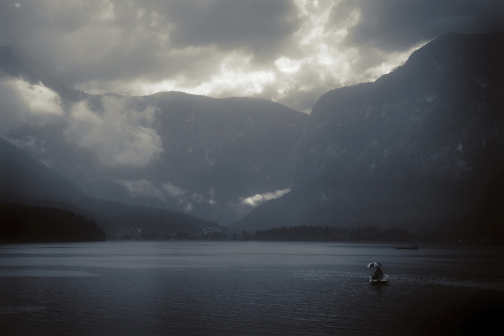 Lone fisherman on misty lake in Hallstatt, Austria by Millie Franz, archival photographic print, available at Ilkaa's Fine Art Gallery.