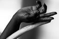 Close-up image of a human hand intertwined with bone by Millie Franz, archival photographic print, available at Ilkaa's Fine Art Gallery.