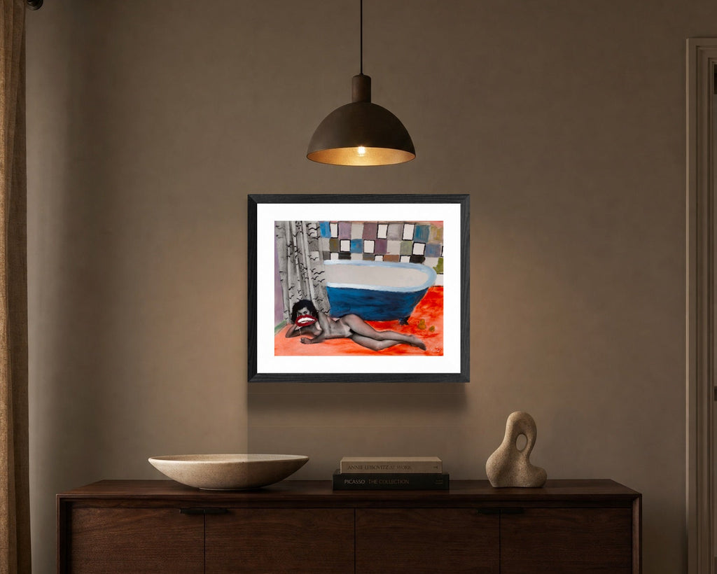Framed artwork on a wall above a wooden cabinet in a room.