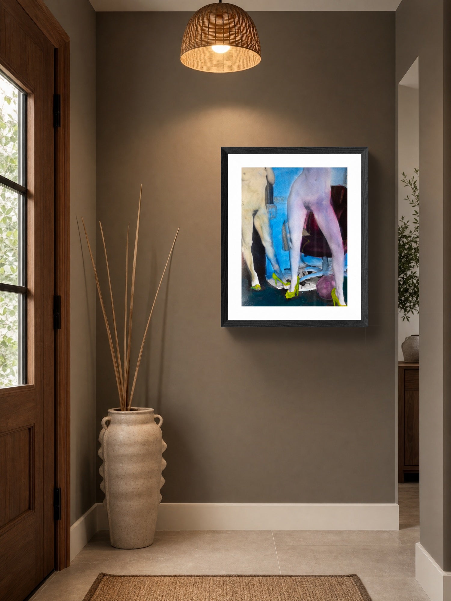 Framed abstract art on a wall in a home interior with a vase and door.